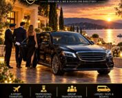Chauffeur opening the door of a black sedan for a couple outside a lakeside resort at sunset.